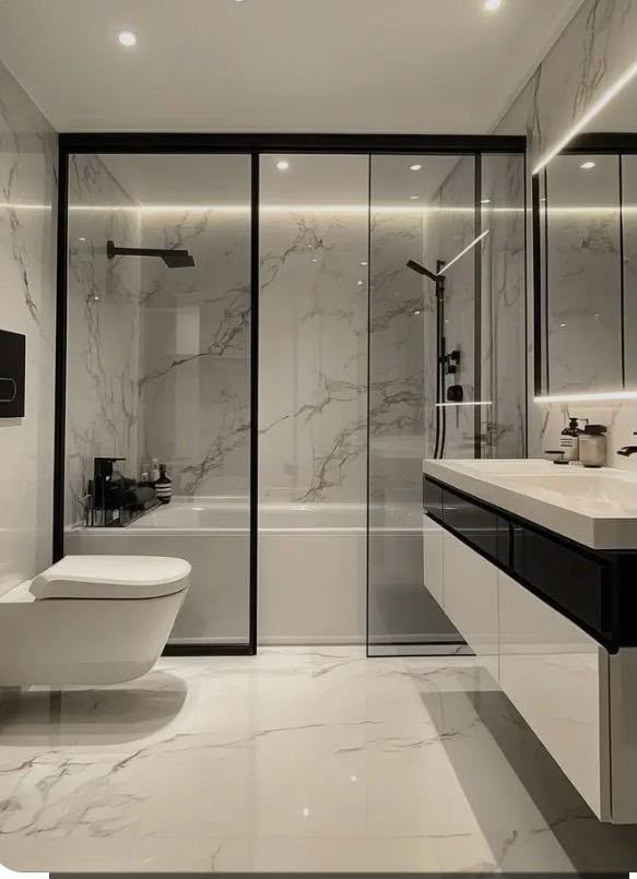 Full-height marble-effect wall tiling and large-format floor tiles in a finished bathroom